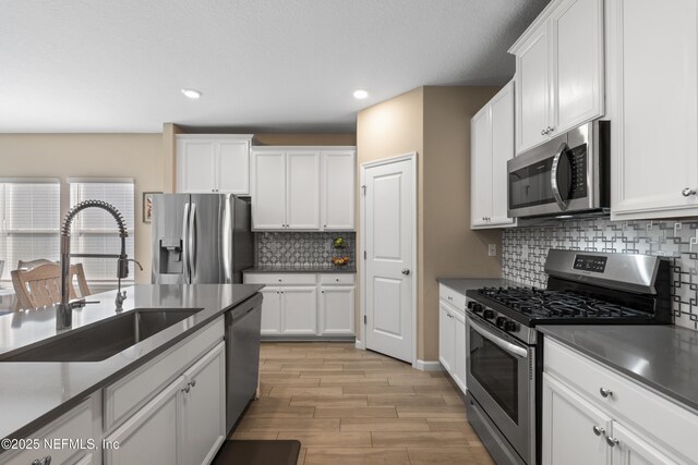 383 Saint Vincent Dr, Saint Augustine, FL 32092 - kitchen featuring stainless steel appliances, a sink, white cabinetry, and recessed lighting