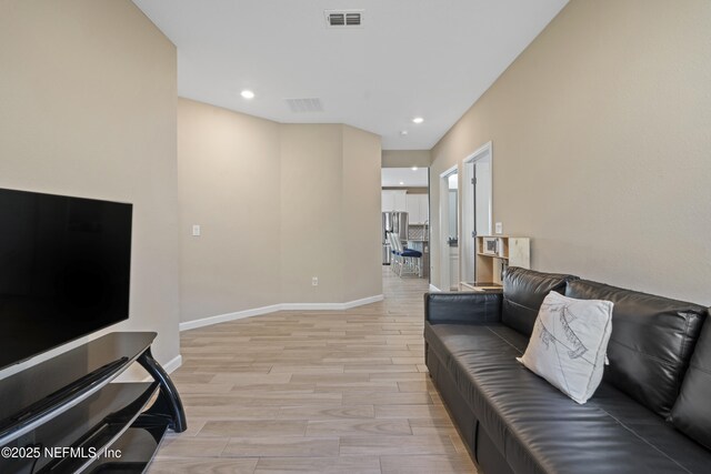383 Saint Vincent Dr, Saint Augustine, FL 32092 - living room featuring light wood-style floors, baseboards, and recessed lighting