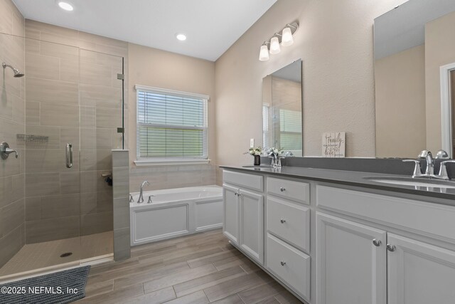 383 Saint Vincent Dr, Saint Augustine, FL 32092 - full bathroom with a shower stall, a bath, double vanity, wood finished floors, and recessed lighting