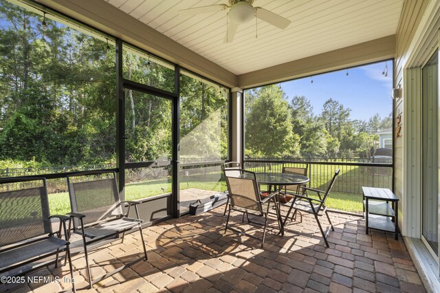 383 Saint Vincent Dr, Saint Augustine, FL 32092 - sunroom featuring ceiling fan, outdoor dining area, and view of wooded area