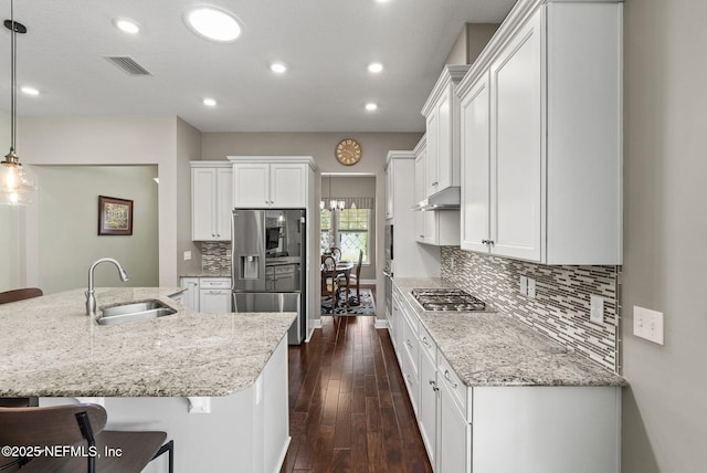 14048 Prater Ct, Jacksonville, FL 32224 - kitchen with a sink, appliances with stainless steel finishes, light stone countertops, under cabinet range hood, and recessed lighting