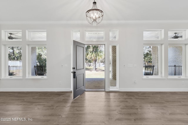 97002 Jose Gaspar Way, Yulee, FL 32097 - entryway featuring a ceiling fan, a chandelier, crown molding, wood finished floors, and baseboards