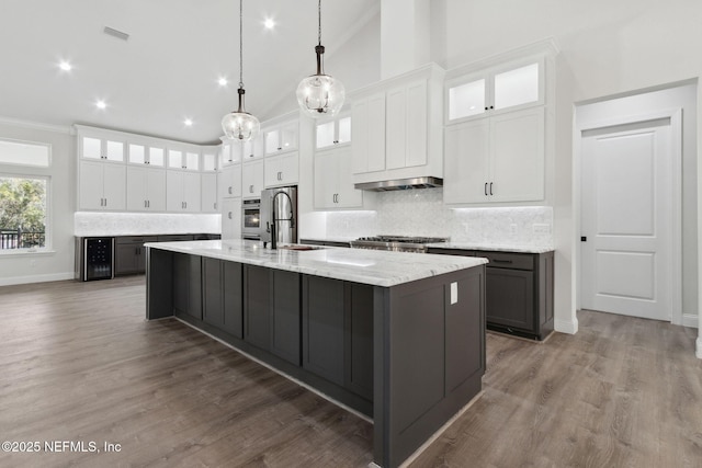 97002 Jose Gaspar Way, Yulee, FL 32097 - kitchen featuring a large island, tasteful backsplash, white cabinets, high vaulted ceiling, and crown molding