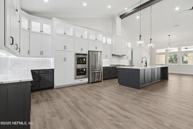 97002 Jose Gaspar Way, Yulee, FL 32097 - kitchen featuring stainless steel appliances, backsplash, beam ceiling, light wood-type flooring, and white cabinetry