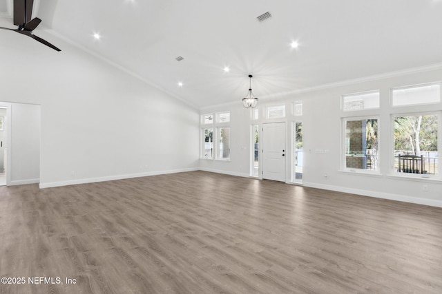 97002 Jose Gaspar Way, Yulee, FL 32097 - unfurnished living room featuring crown molding, baseboards, wood finished floors, a chandelier, and a ceiling fan