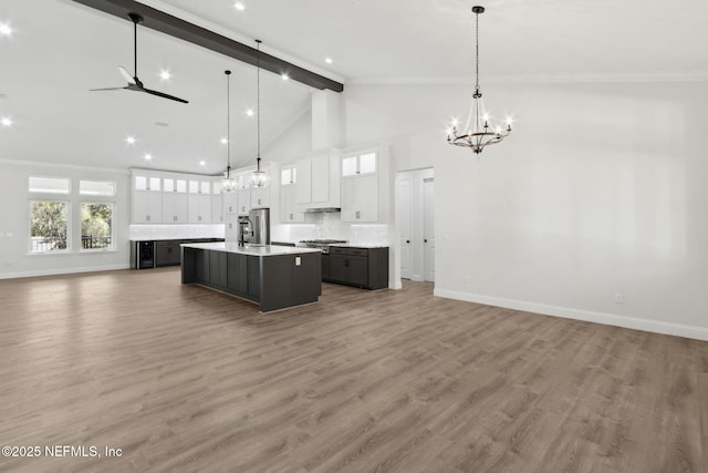 97002 Jose Gaspar Way, Yulee, FL 32097 - kitchen with open floor plan, a chandelier, beam ceiling, a spacious island, and a sink