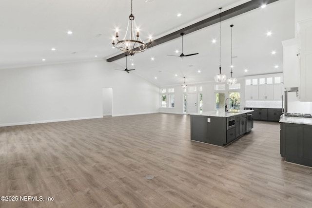 97002 Jose Gaspar Way, Yulee, FL 32097 - kitchen with a ceiling fan, a chandelier, open floor plan, white cabinetry, and a sink