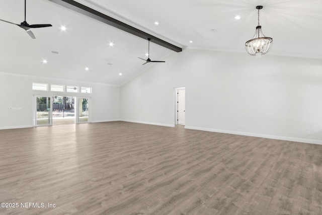 97002 Jose Gaspar Way, Yulee, FL 32097 - unfurnished living room featuring a ceiling fan, beam ceiling, baseboards, light wood-style flooring, and a chandelier
