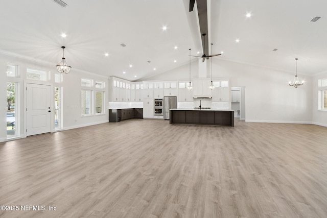 97002 Jose Gaspar Way, Yulee, FL 32097 - unfurnished living room featuring a chandelier, baseboards, high vaulted ceiling, light wood-style floors, and recessed lighting