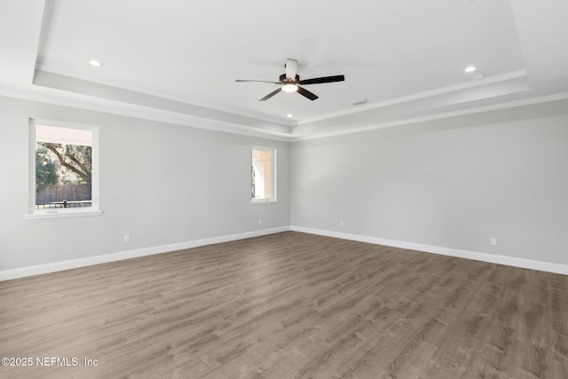 97002 Jose Gaspar Way, Yulee, FL 32097 - unfurnished room featuring a raised ceiling, ornamental molding, ceiling fan, baseboards, and wood finished floors