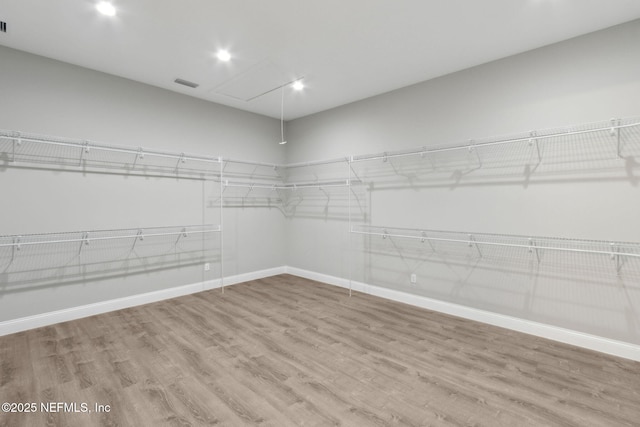 97002 Jose Gaspar Way, Yulee, FL 32097 - walk in closet featuring attic access and wood finished floors