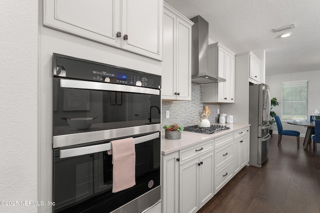 275 Kellet Way, Saint Johns, FL 32259 - kitchen with wall chimney exhaust hood, appliances with stainless steel finishes, backsplash, light countertops, and a textured ceiling