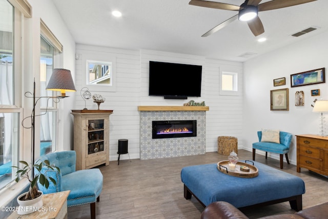 219 Heron Landing Rd, Saint Johns, FL 32259 - living room with a tile fireplace, wood finished floors, ceiling fan, baseboards, and recessed lighting