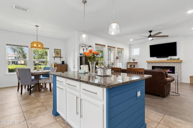 219 Heron Landing Rd, Saint Johns, FL 32259 - kitchen with plenty of natural light, a ceiling fan, white cabinets, a kitchen island, and recessed lighting