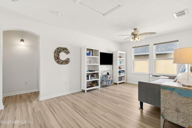 219 Heron Landing Rd, Saint Johns, FL 32259 - office area featuring wood finished floors, baseboards, a ceiling fan, and arched walkways
