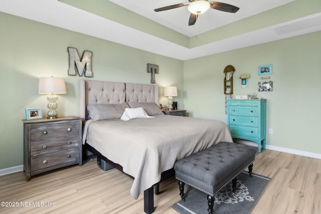 219 Heron Landing Rd, Saint Johns, FL 32259 - bedroom with wood finished floors, baseboards, a raised ceiling, and a ceiling fan