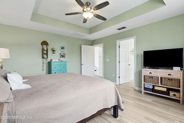 219 Heron Landing Rd, Saint Johns, FL 32259 - bedroom featuring a tray ceiling, wood finished floors, ceiling fan, and baseboards