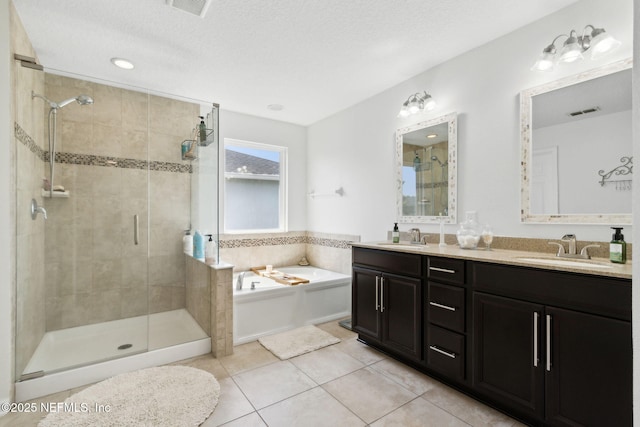 219 Heron Landing Rd, Saint Johns, FL 32259 - bathroom featuring a stall shower, tile patterned flooring, a bath, double vanity, and recessed lighting