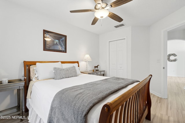 219 Heron Landing Rd, Saint Johns, FL 32259 - bedroom with a closet, light wood-style flooring, a ceiling fan, and baseboards
