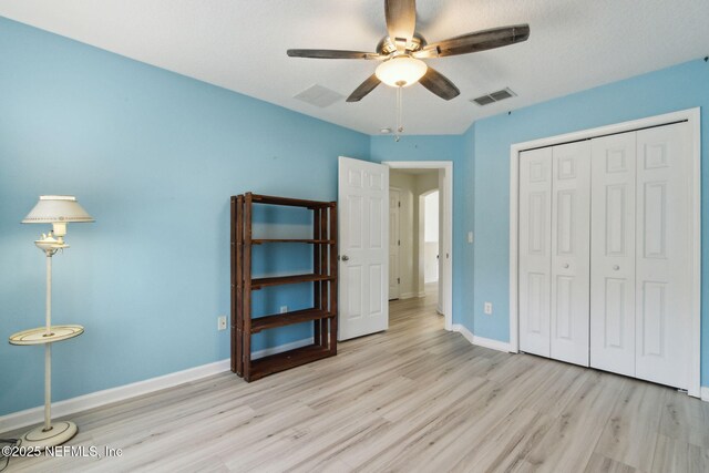 219 Heron Landing Rd, Saint Johns, FL 32259 - bedroom with wood finished floors, a closet, baseboards, and a ceiling fan