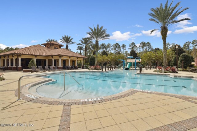 219 Heron Landing Rd, Saint Johns, FL 32259 - community pool featuring a water slide and a patio area