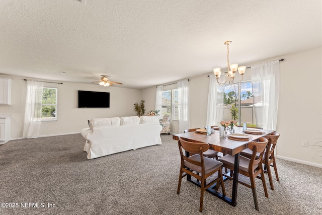 dining area featuring a chandelier, carpet flooring, a textured ceiling, a ceiling fan, and baseboards