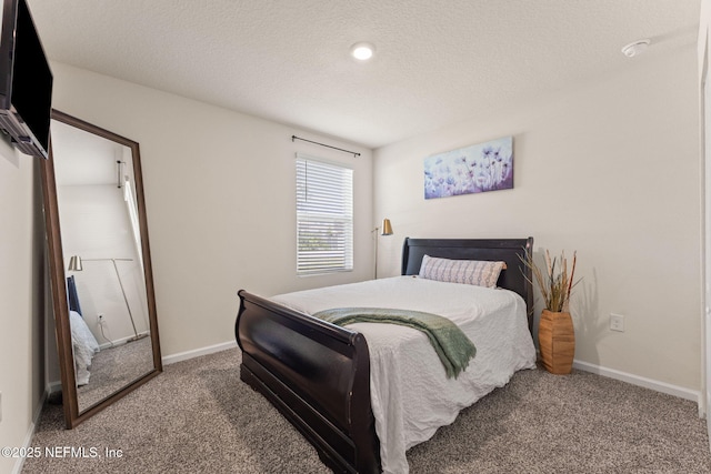 bedroom featuring carpet floors, baseboards, and a textured ceiling