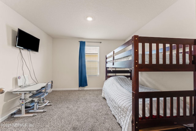 bedroom featuring carpet, baseboards, and a textured ceiling