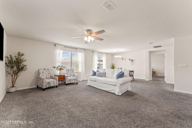 carpeted living area with ceiling fan, a textured ceiling, a chandelier, and baseboards