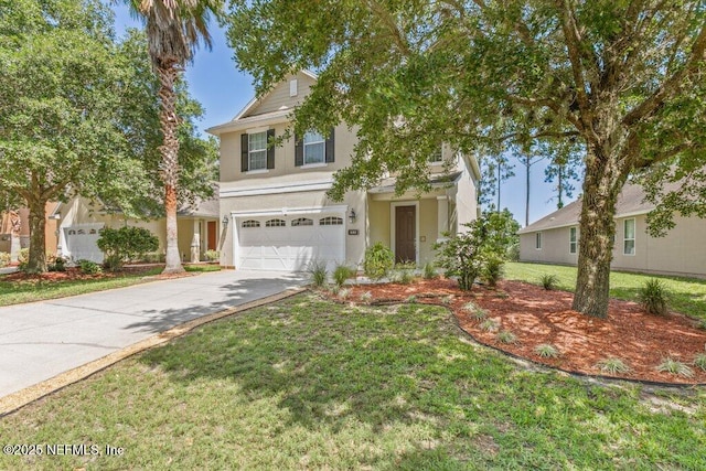 680 Briar View Dr, Orange Park, FL 32065 - view of front facade featuring a garage, driveway, stucco siding, and a front yard