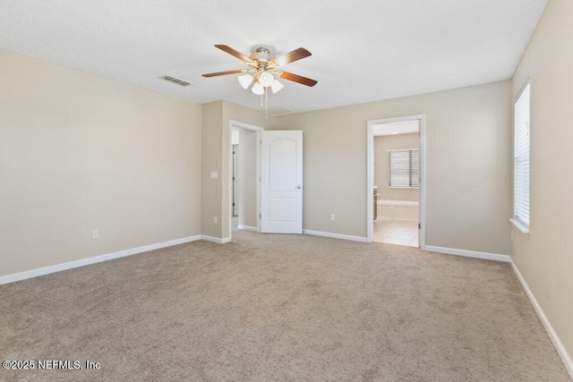 680 Briar View Dr, Orange Park, FL 32065 - unfurnished bedroom featuring light colored carpet, ensuite bath, baseboards, and ceiling fan