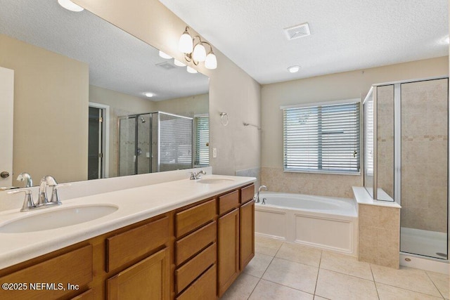 680 Briar View Dr, Orange Park, FL 32065 - full bathroom featuring tile patterned flooring, a shower stall, a bath, a textured ceiling, and double vanity