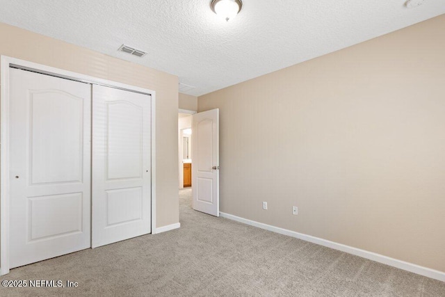 680 Briar View Dr, Orange Park, FL 32065 - unfurnished bedroom featuring carpet, a closet, baseboards, and a textured ceiling