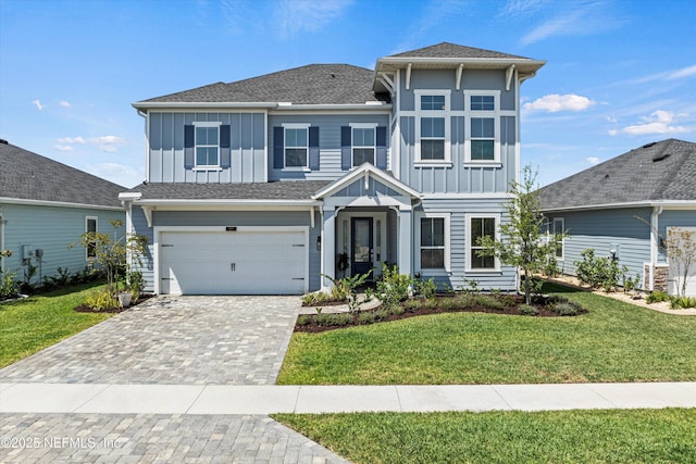 97 Lily Landing Dr, Saint Augustine, FL 32092 - view of front facade with board and batten siding, a front yard, an attached garage, and decorative driveway