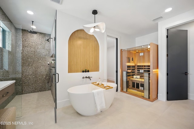 full bath with a stall shower, a soaking tub, and recessed lighting