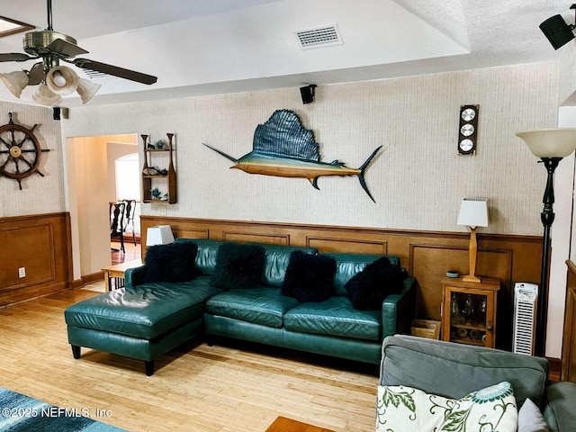 1734 Alps Ct, Fleming Island, FL 32003 - living area featuring ceiling fan, wallpapered walls, wood finished floors, and a wainscoted wall