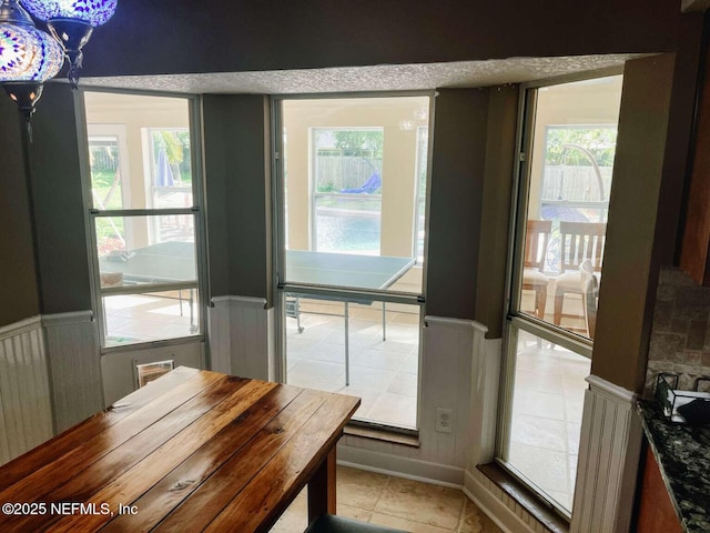 1734 Alps Ct, Fleming Island, FL 32003 - dining room with a wainscoted wall and light tile patterned floors