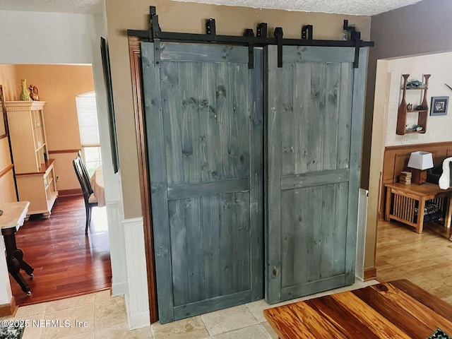 1734 Alps Ct, Fleming Island, FL 32003 - detailed view of a barn door, wainscoting, and wood finished floors