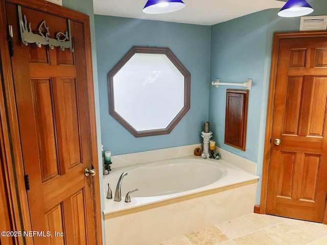 1734 Alps Ct, Fleming Island, FL 32003 - bathroom featuring a garden tub and tile patterned floors