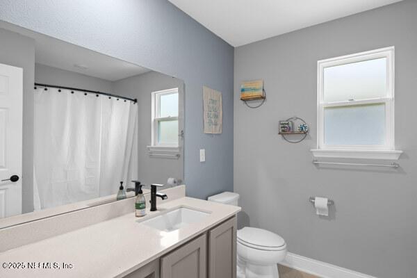 2768 Windsor Lakes Way, Green Cove Springs, FL 32043 - full bathroom with toilet, baseboards, vanity, and a shower with curtain