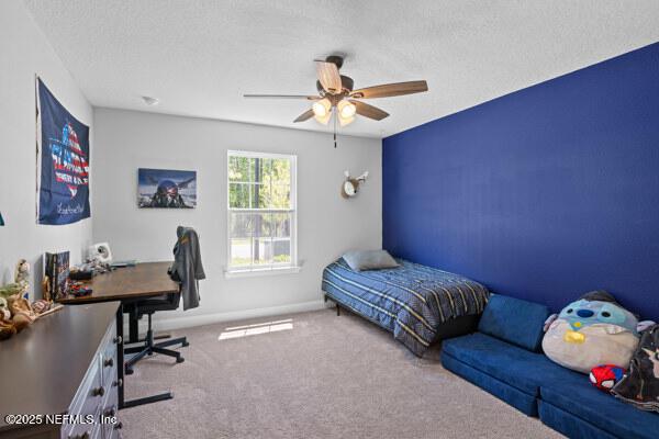 2768 Windsor Lakes Way, Green Cove Springs, FL 32043 - bedroom featuring carpet flooring, a desk, a textured ceiling, baseboards, and ceiling fan