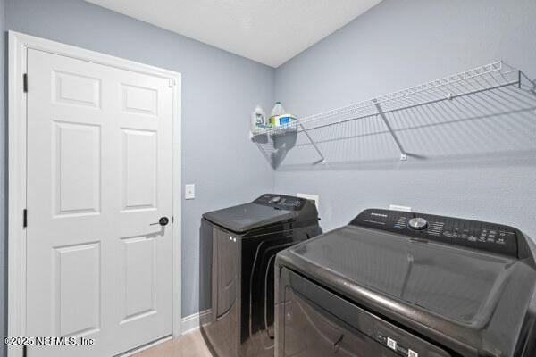 2768 Windsor Lakes Way, Green Cove Springs, FL 32043 - clothes washing area featuring independent washer and dryer, baseboards, and wood finished floors
