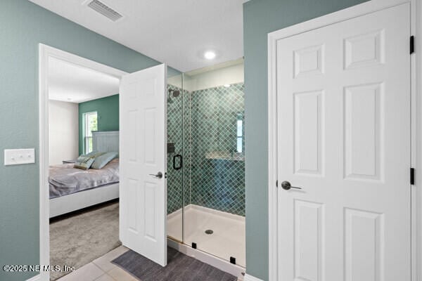 2768 Windsor Lakes Way, Green Cove Springs, FL 32043 - ensuite bathroom featuring tile patterned floors, a shower stall, and baseboards