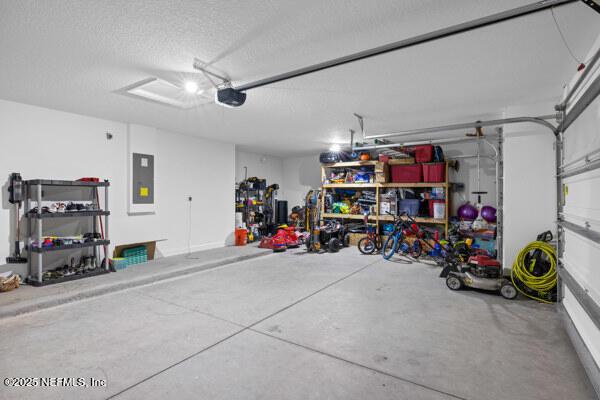 2768 Windsor Lakes Way, Green Cove Springs, FL 32043 - garage with electric panel and a garage door opener