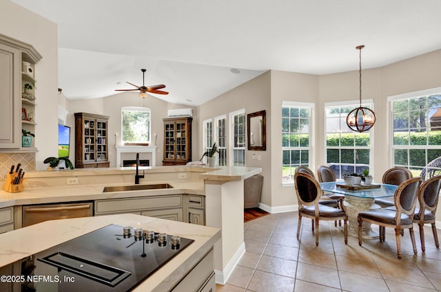 3854 Painted Bunting Way, Jacksonville, FL 32224 - kitchen with stainless steel dishwasher, a sink, a chandelier, healthy amount of natural light, and vaulted ceiling