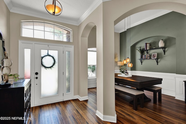 3854 Painted Bunting Way, Jacksonville, FL 32224 - foyer featuring arched walkways, dark wood finished floors, and ornamental molding