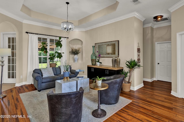 3854 Painted Bunting Way, Jacksonville, FL 32224 - living room with arched walkways, wood-type flooring, a tray ceiling, baseboards, and crown molding