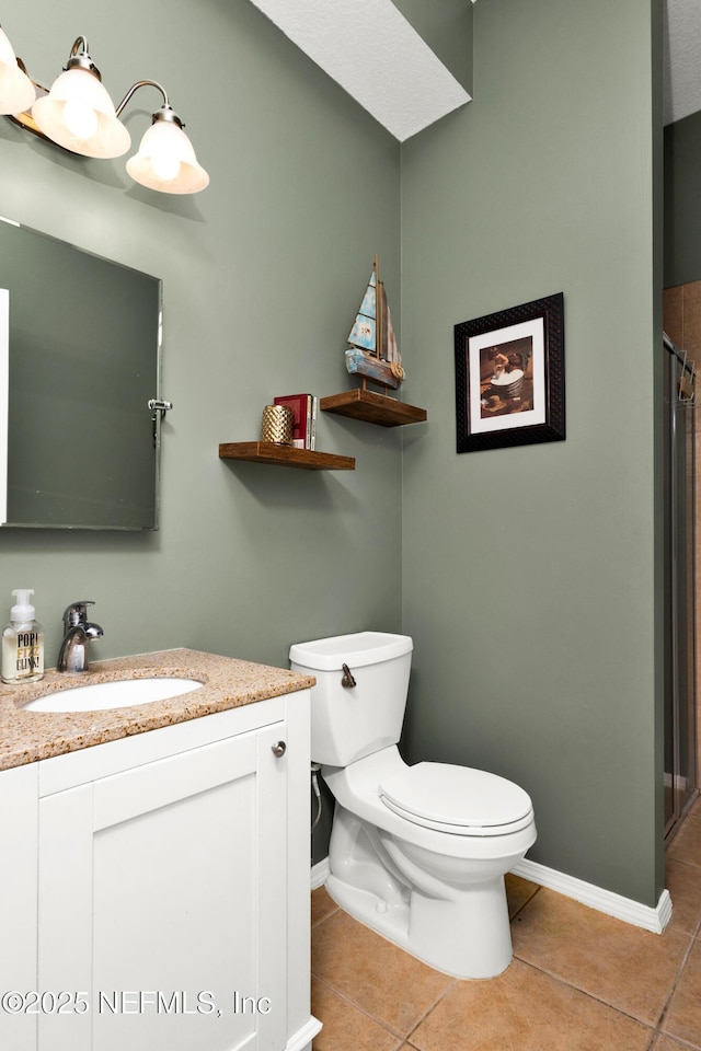 3854 Painted Bunting Way, Jacksonville, FL 32224 - bathroom with tile patterned flooring, toilet, vanity, a shower, and baseboards