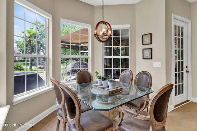 3854 Painted Bunting Way, Jacksonville, FL 32224 - dining room with a chandelier, light tile patterned flooring, and baseboards