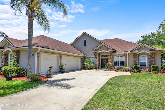 3854 Painted Bunting Way, Jacksonville, FL 32224 - view of front of home with stucco siding, stone siding, an attached garage, and driveway
